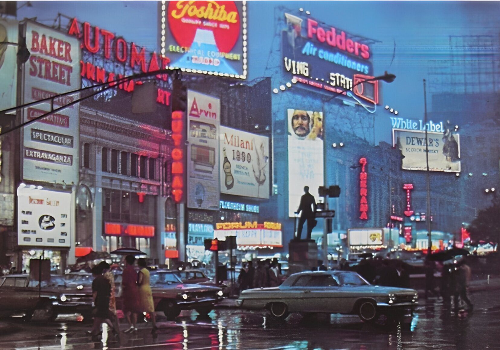 Busy city street at night with bright neon signs and vintage cars.